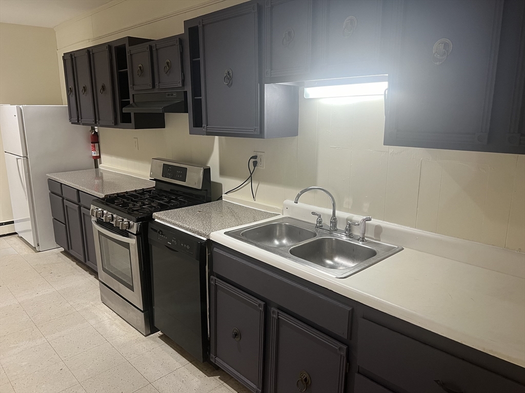 a kitchen with a sink and cabinets