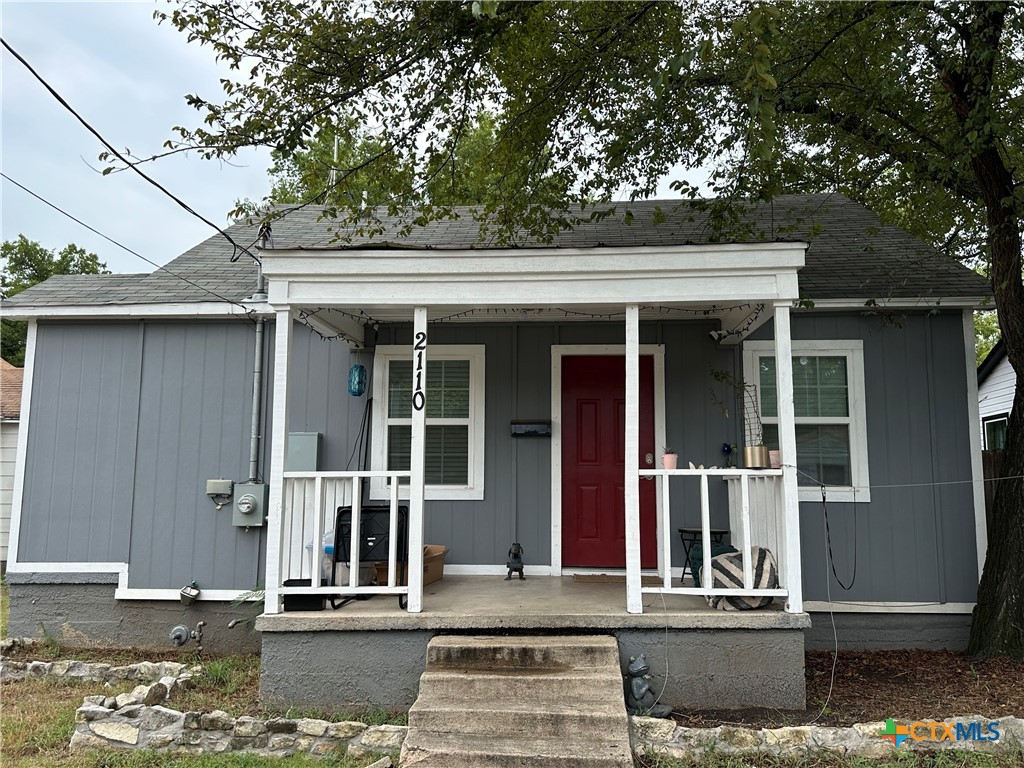 front view of a house with a tree