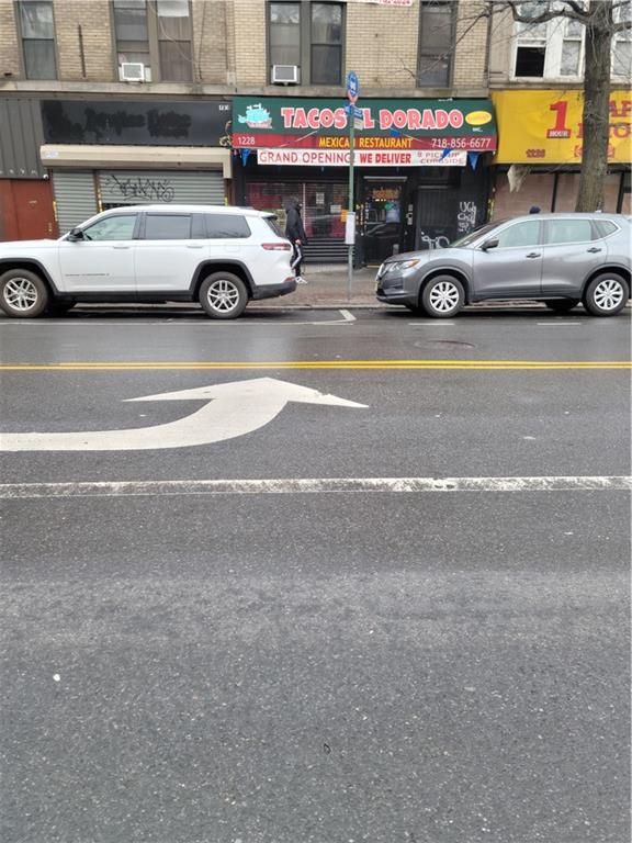 a car parked in the street next to a building