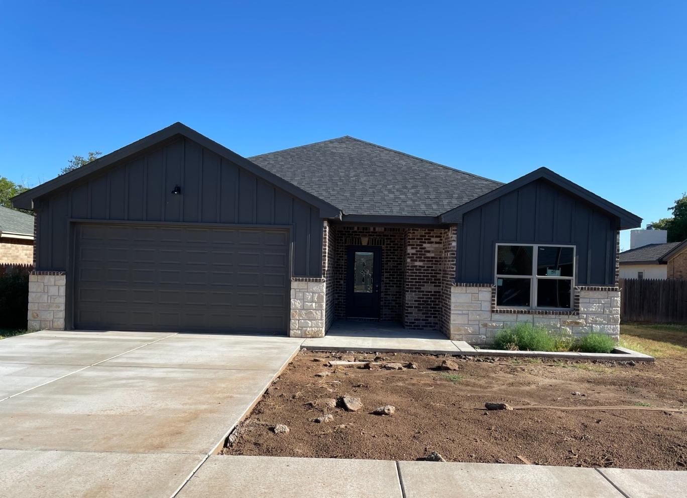 a front view of a house with garage