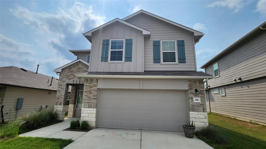 a front view of a house with garage