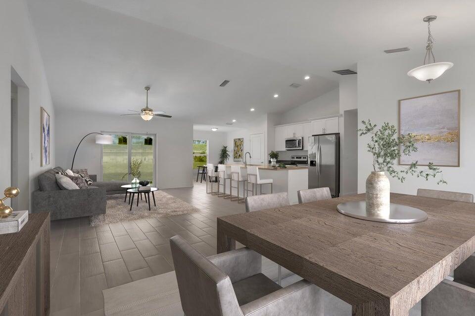 an open kitchen with granite countertop a table and chairs