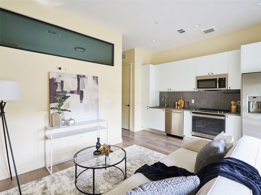 a living room with furniture or kitchen view and a fireplace