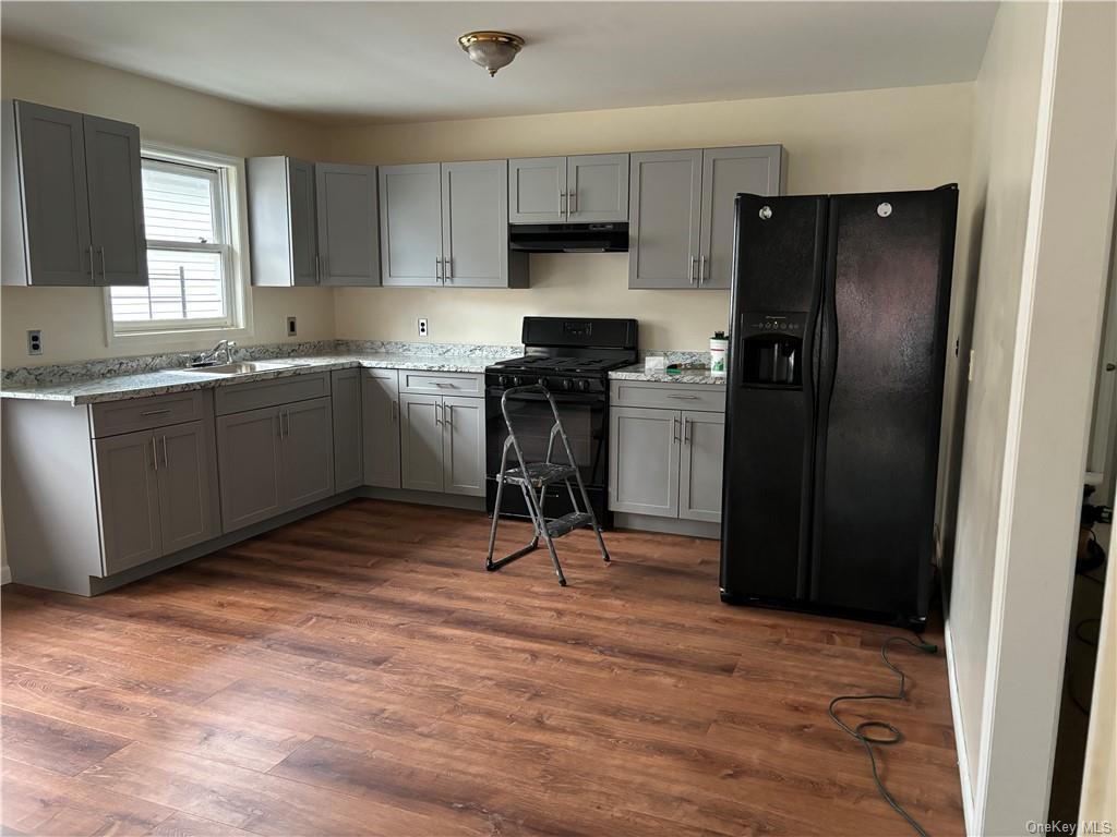 a kitchen with a refrigerator and a stove top oven