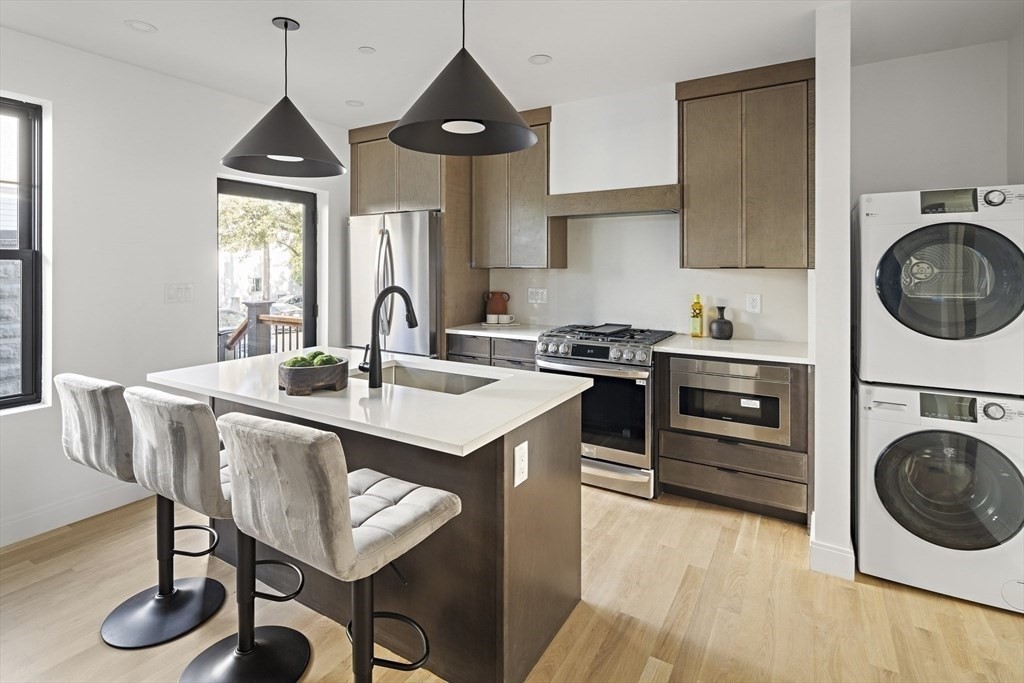 a kitchen with a stove a sink and a refrigerator