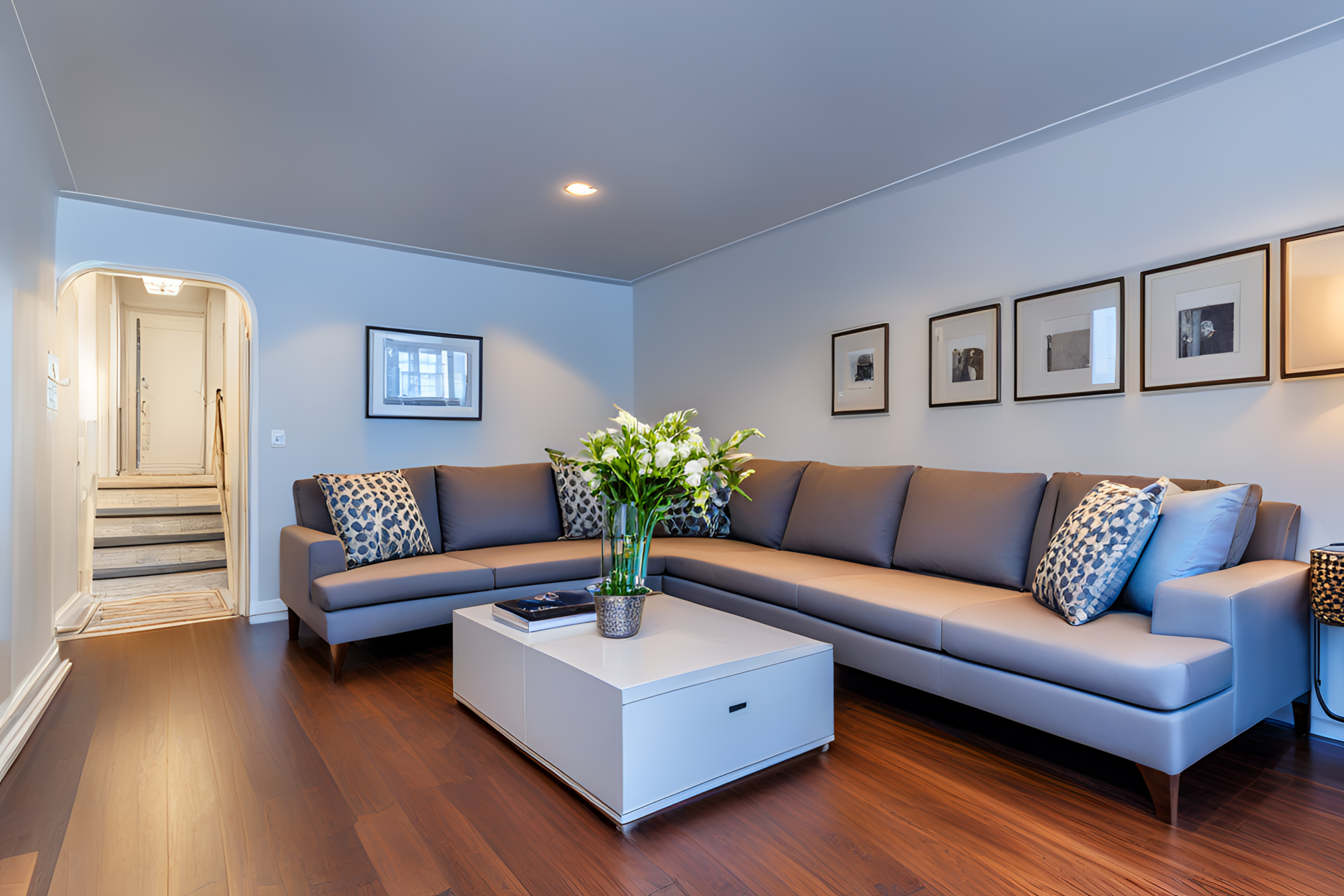 a living room with furniture and a wooden floor