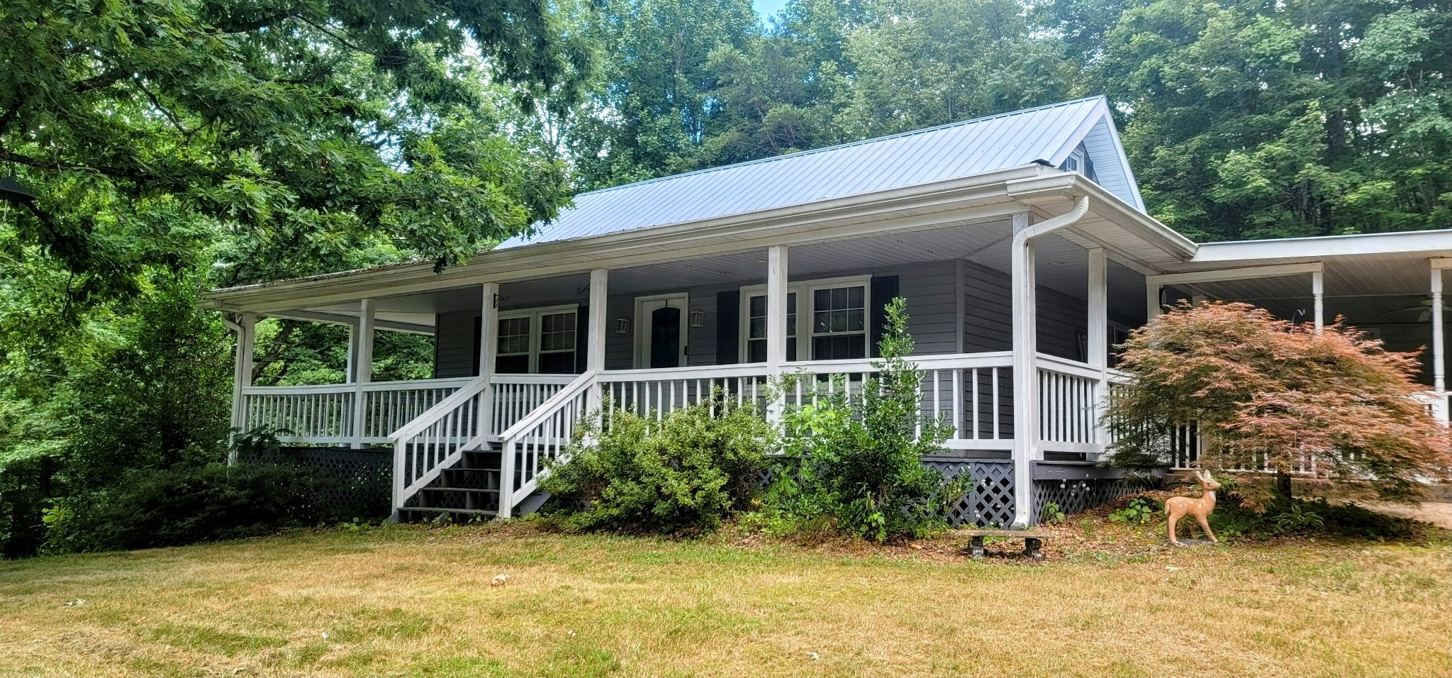 a view of a house with backyard porch and sitting area