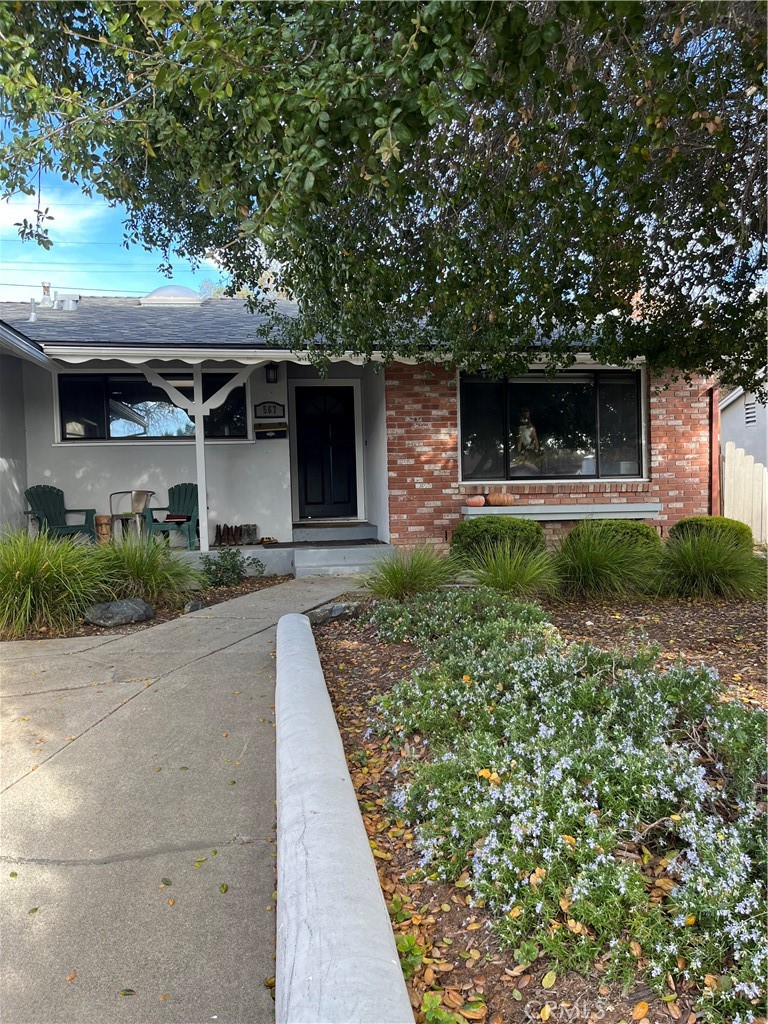 a front view of a house with garden