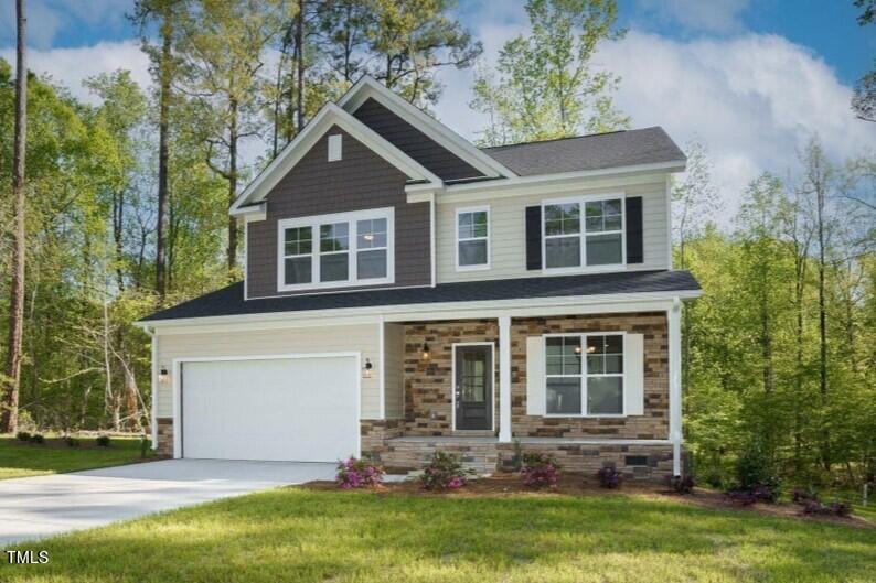 a front view of a house with a yard and garage