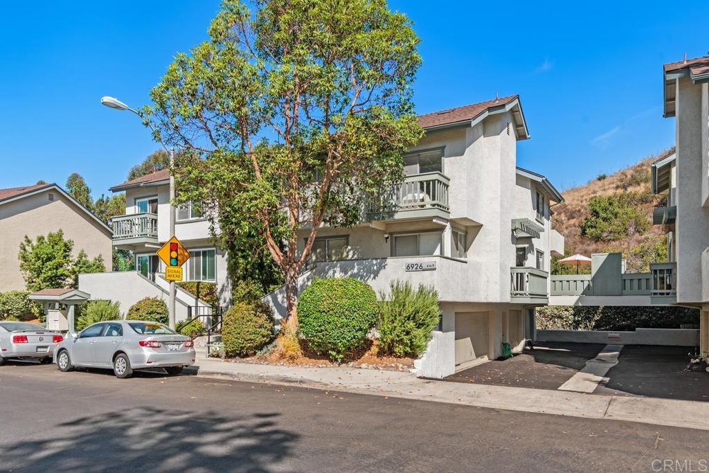 front view of a house with a cars park