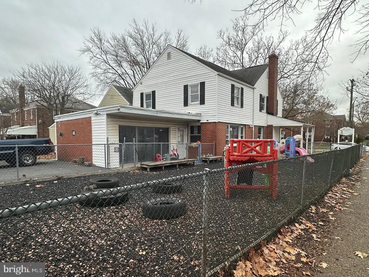 a view of a house with a yard patio and fire pit