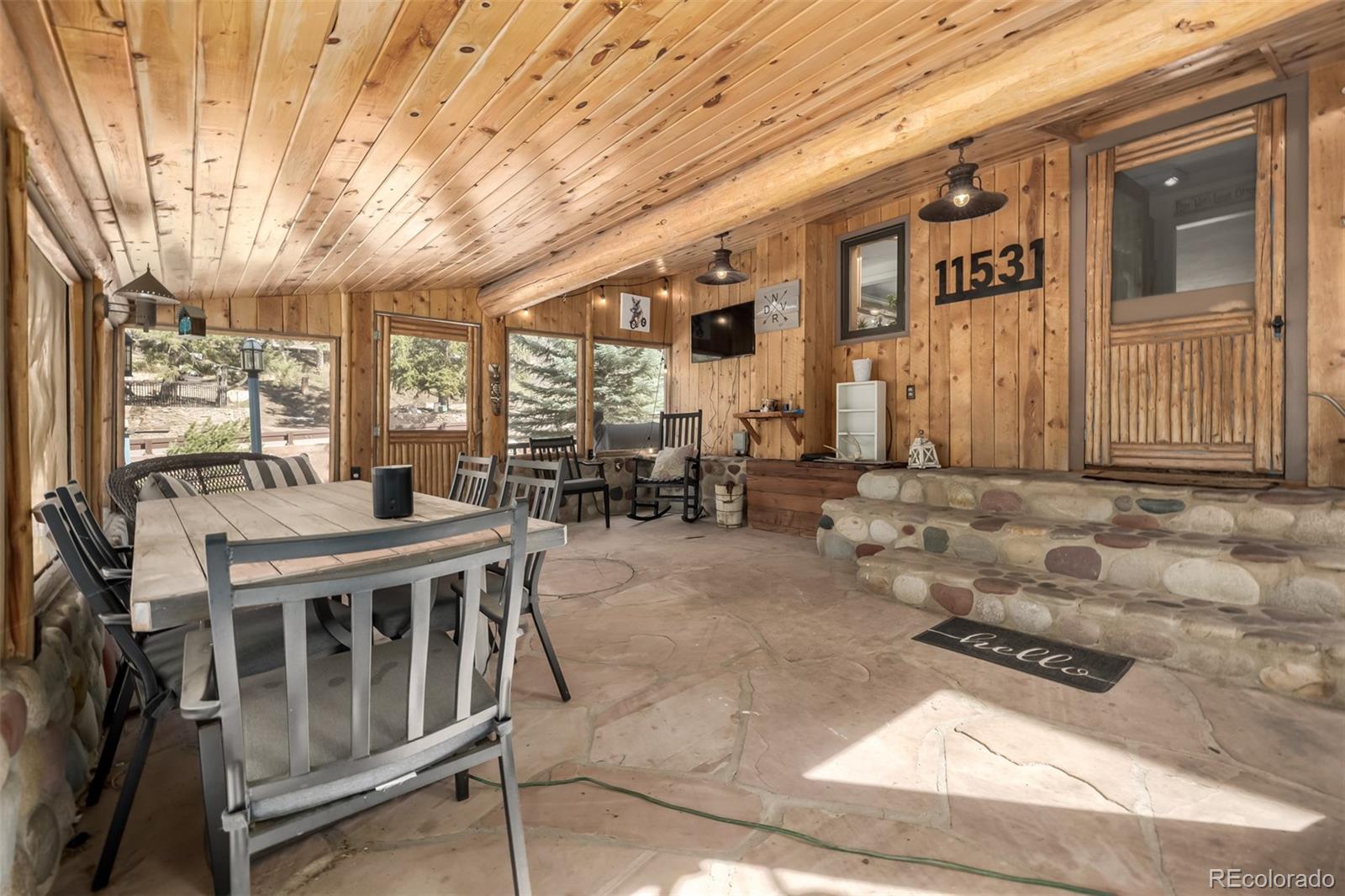 a view of a patio with couches table and chairs and potted plants