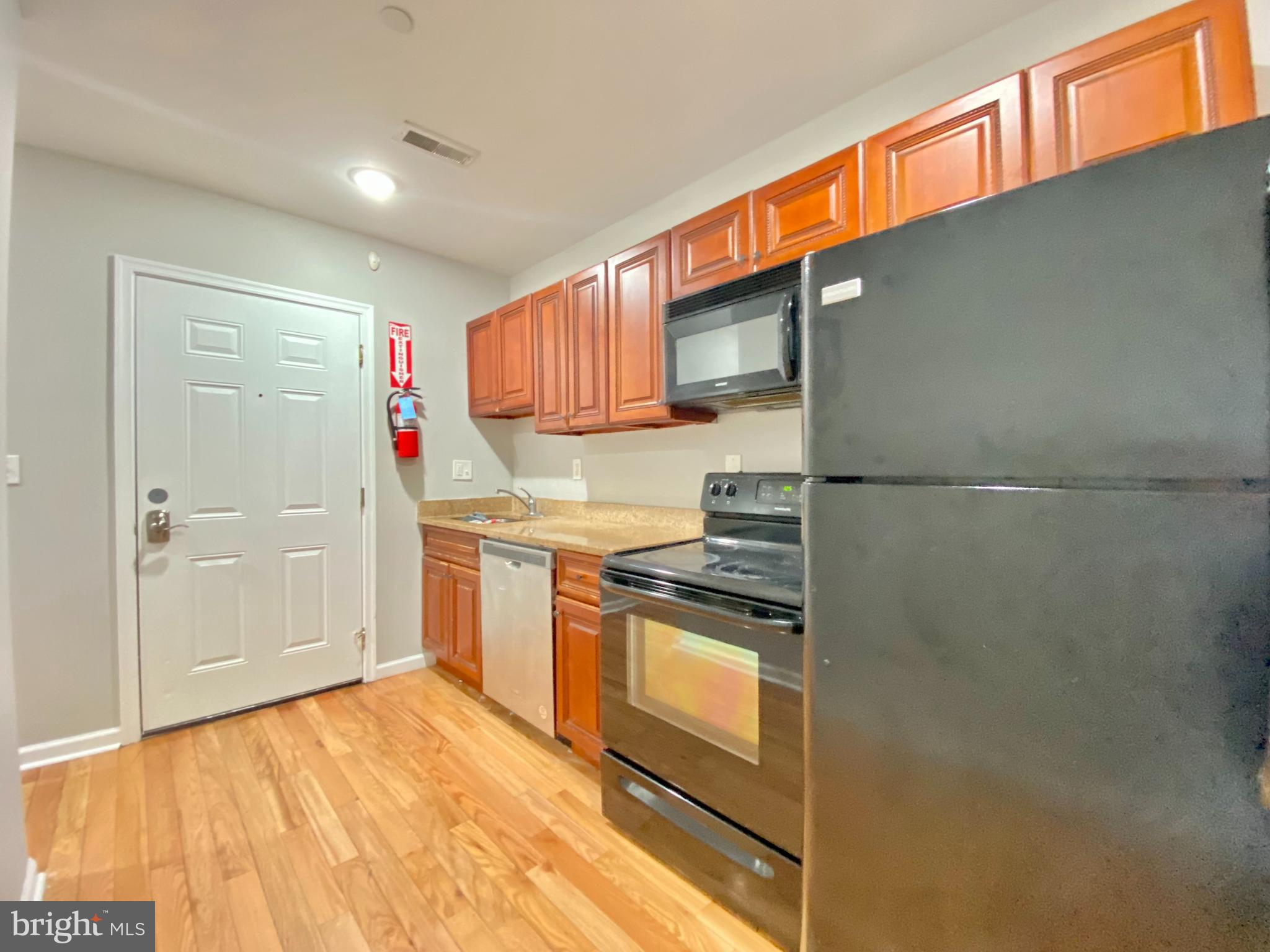 a kitchen with stainless steel appliances granite countertop a refrigerator and a stove top oven