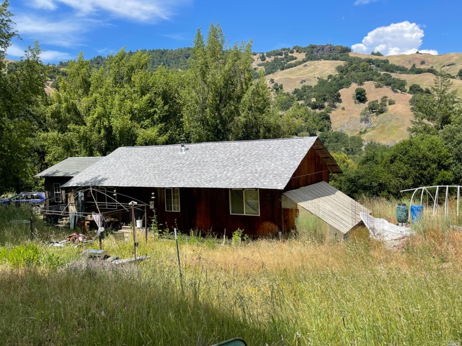 a view of a house with pool and a yard