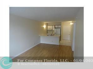 a view of kitchen and an empty room