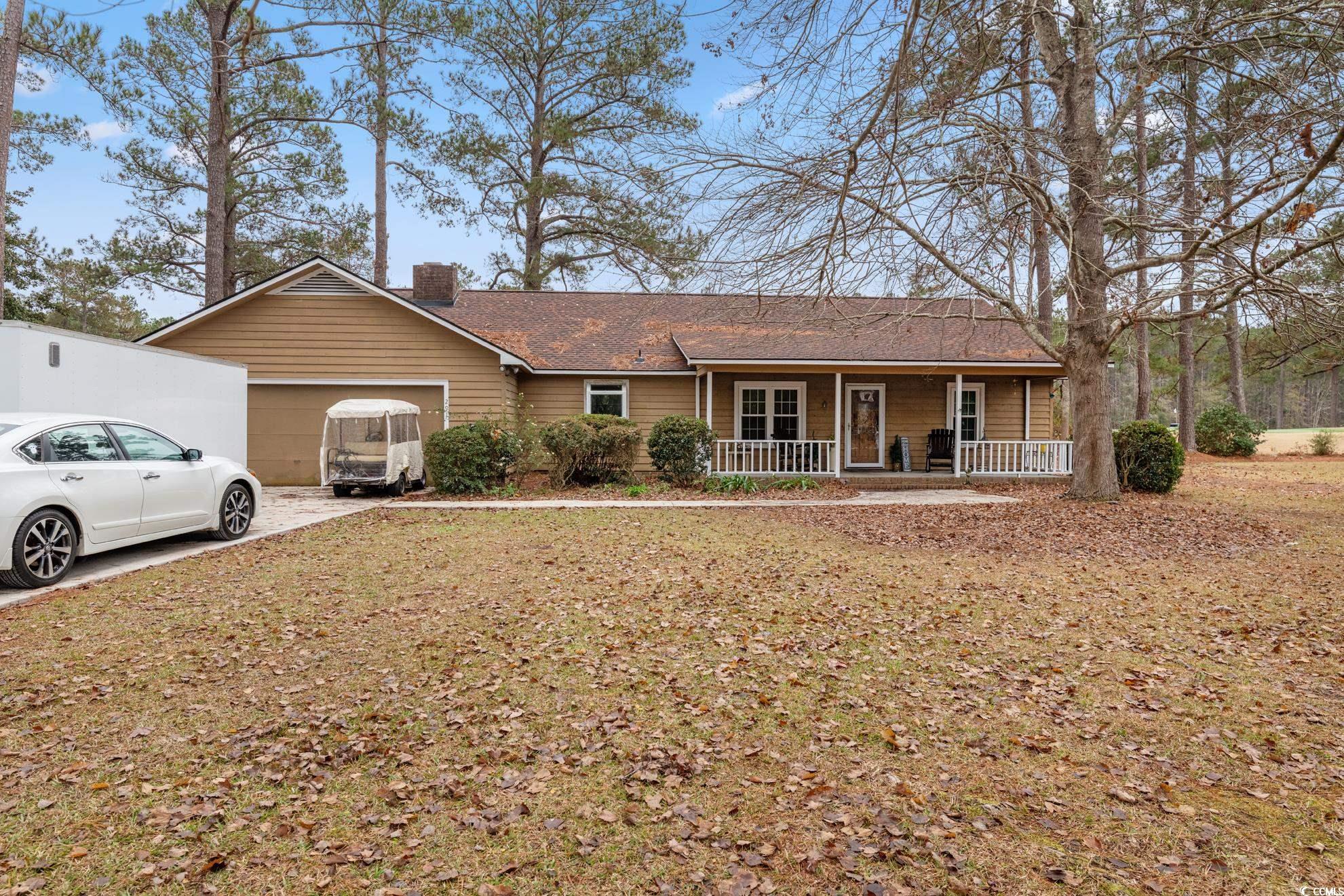 Ranch-style home with a porch and a garage