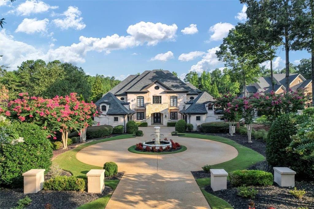 a front view of a house with fountain bath tub and trees