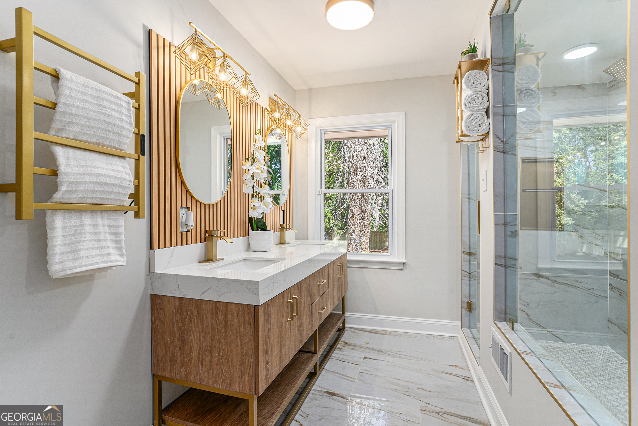 a bathroom with a double vanity sink mirror and shower