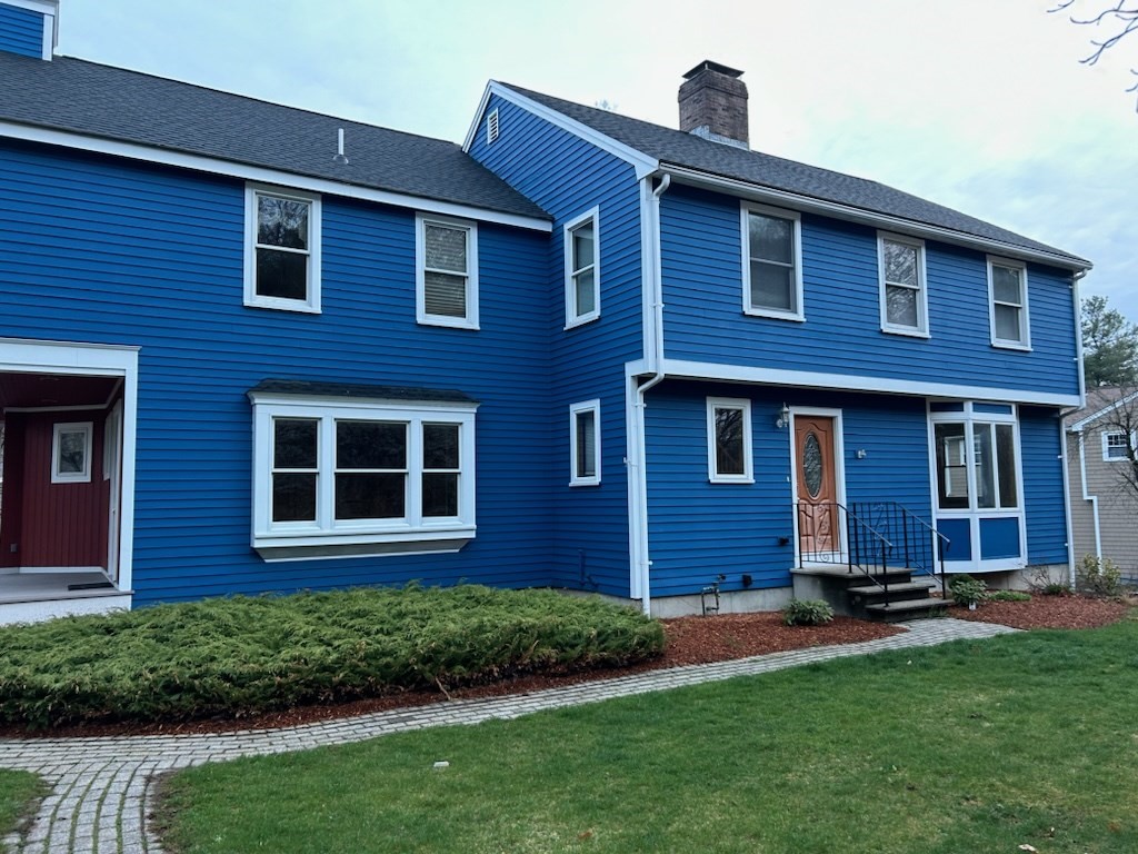 a view of a brick house with a yard