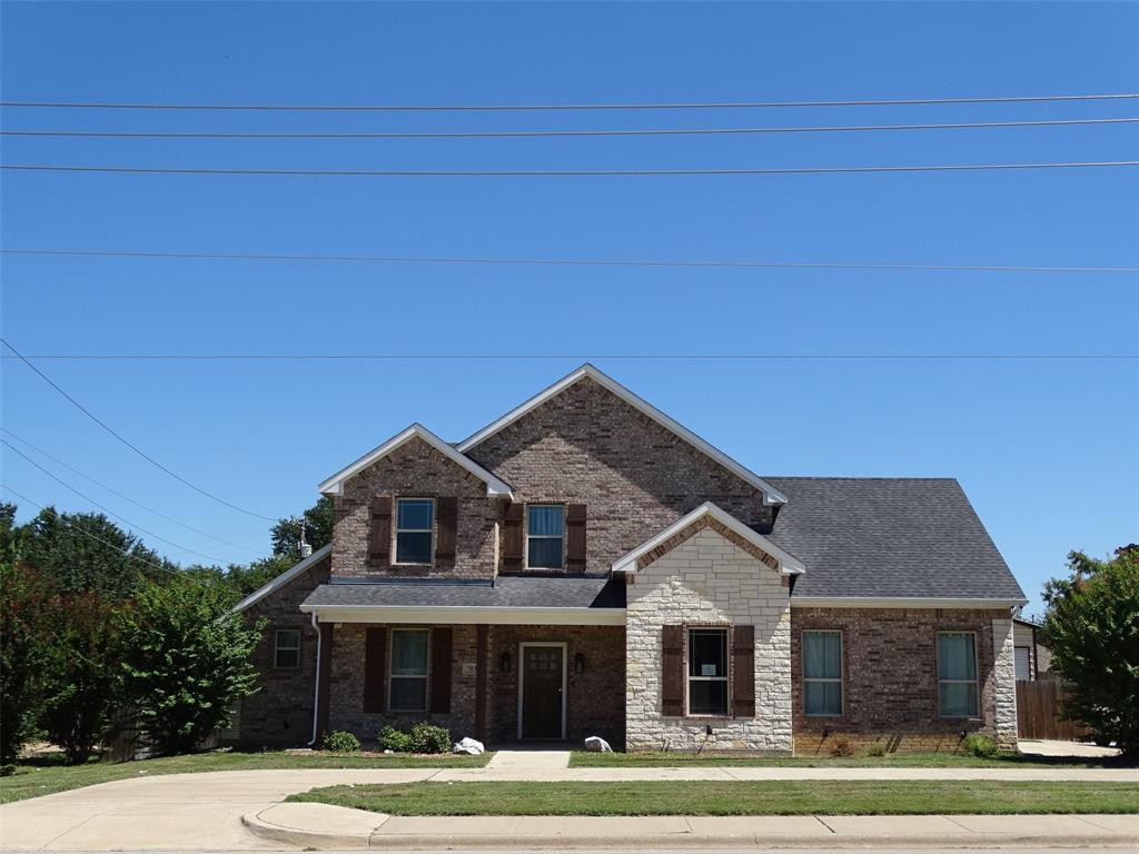 a front view of a house with a yard