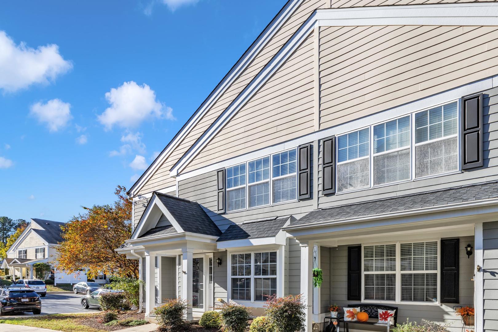 a front view of a residential apartment building with a yard