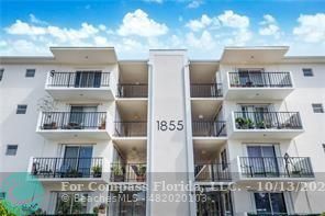 a front view of a residential apartment building with a yard