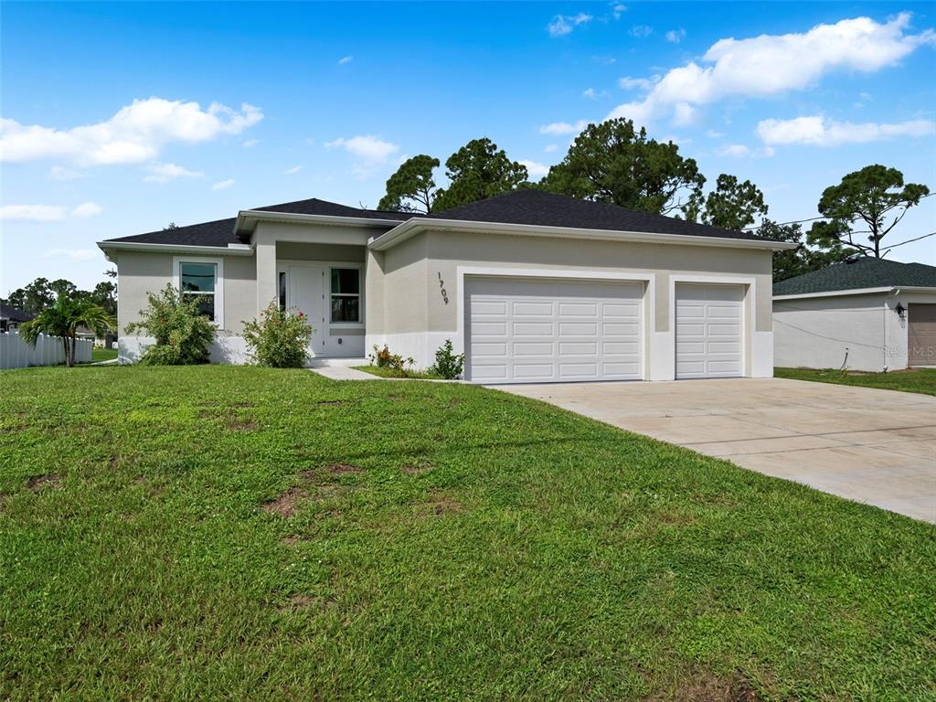 a front view of a house with a yard and garage