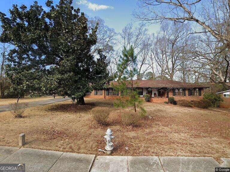 a view of a house with a tree