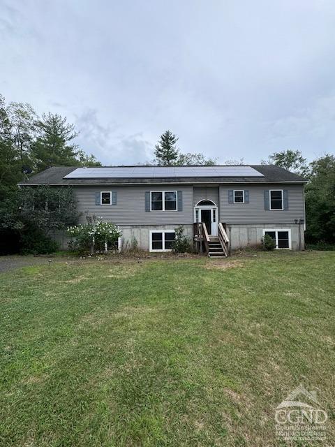 a front view of house with yard and outdoor seating