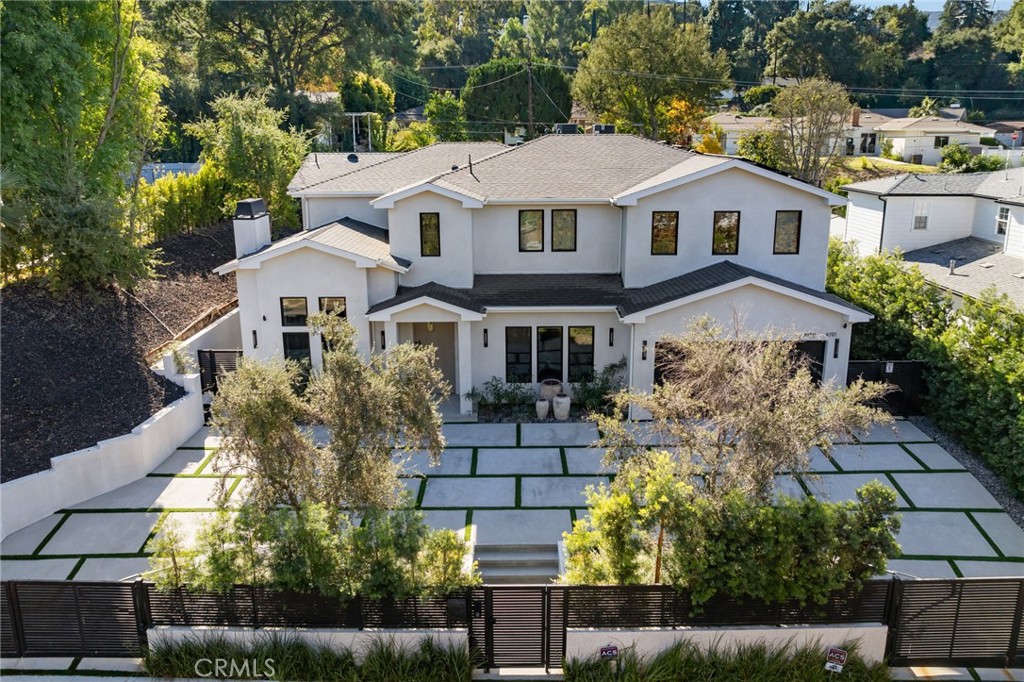 a aerial view of a house with a yard and potted plants