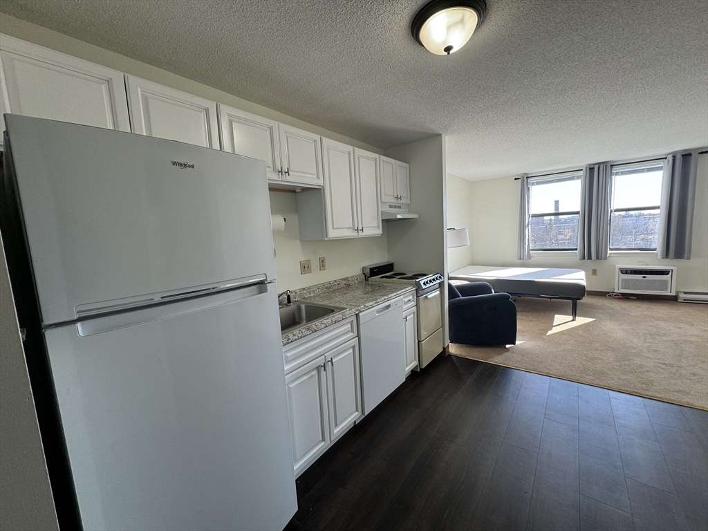 a kitchen with white cabinets and white appliances