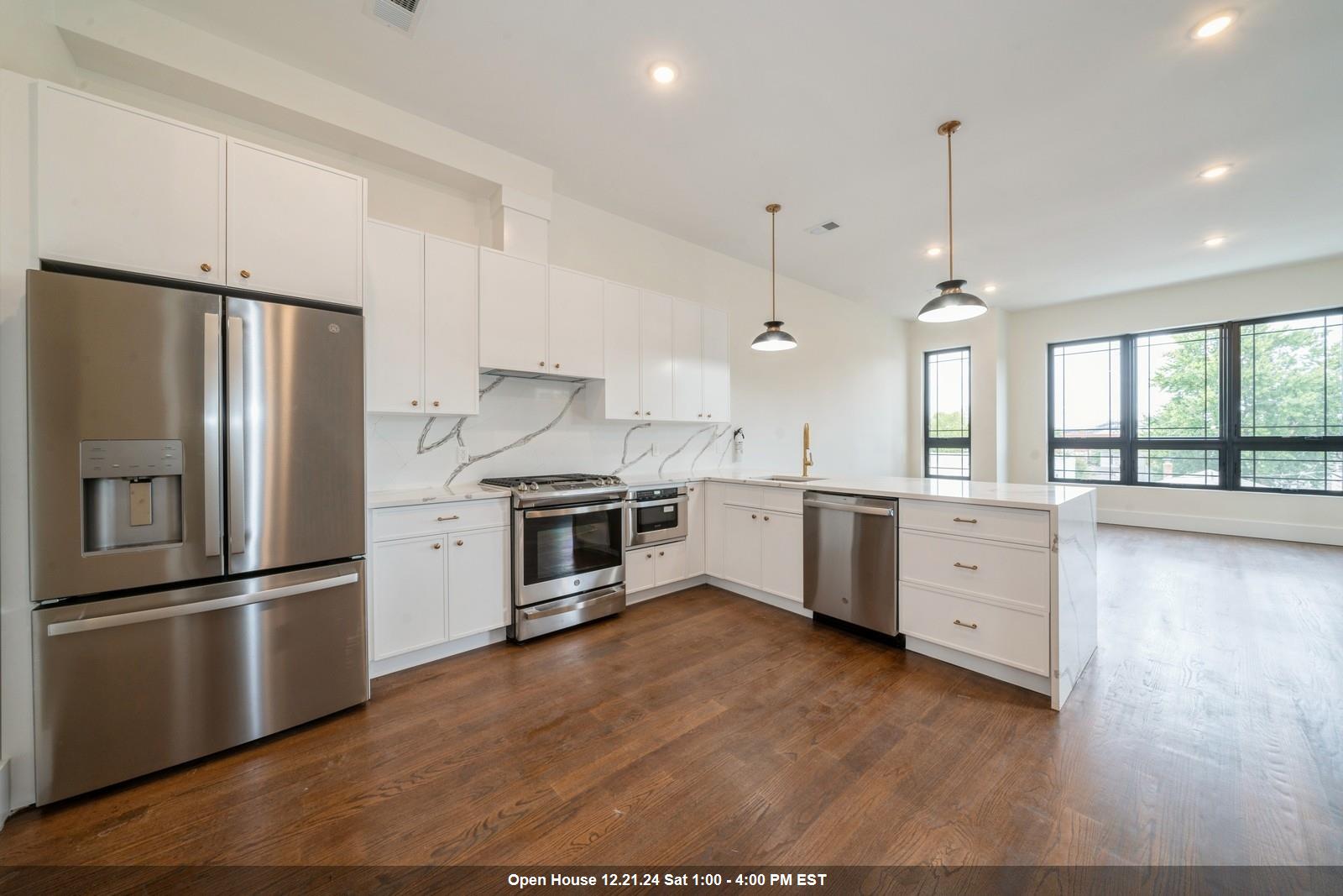 a kitchen with stainless steel appliances a refrigerator sink and cabinets