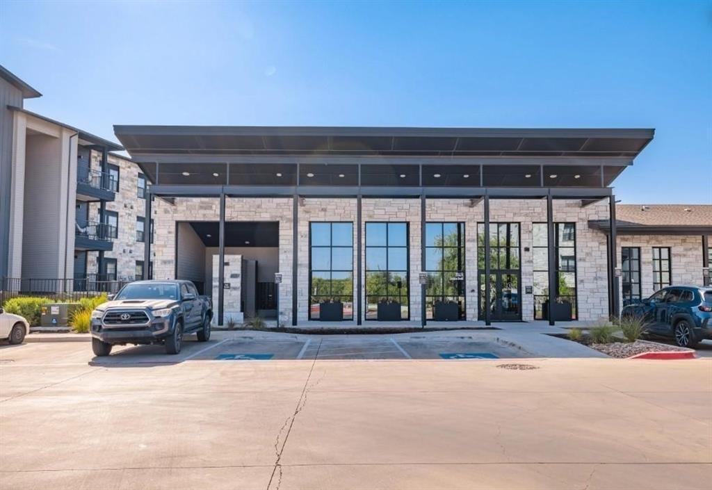 a view of a building with car parked