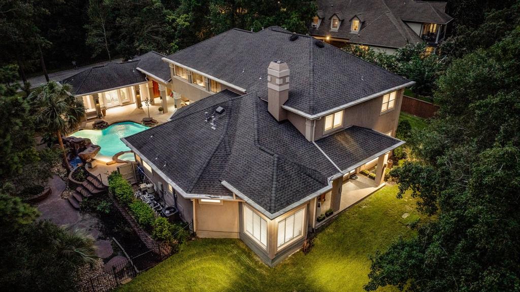 an aerial view of house with yard swimming pool and outdoor seating