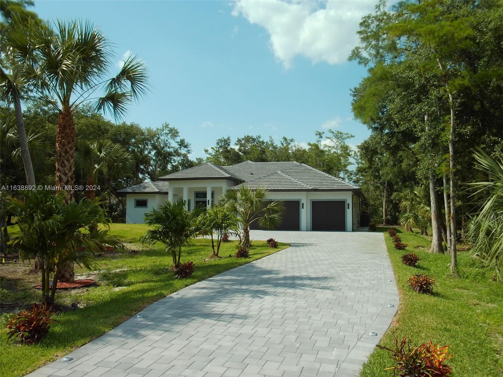 a front view of house with yard and green space