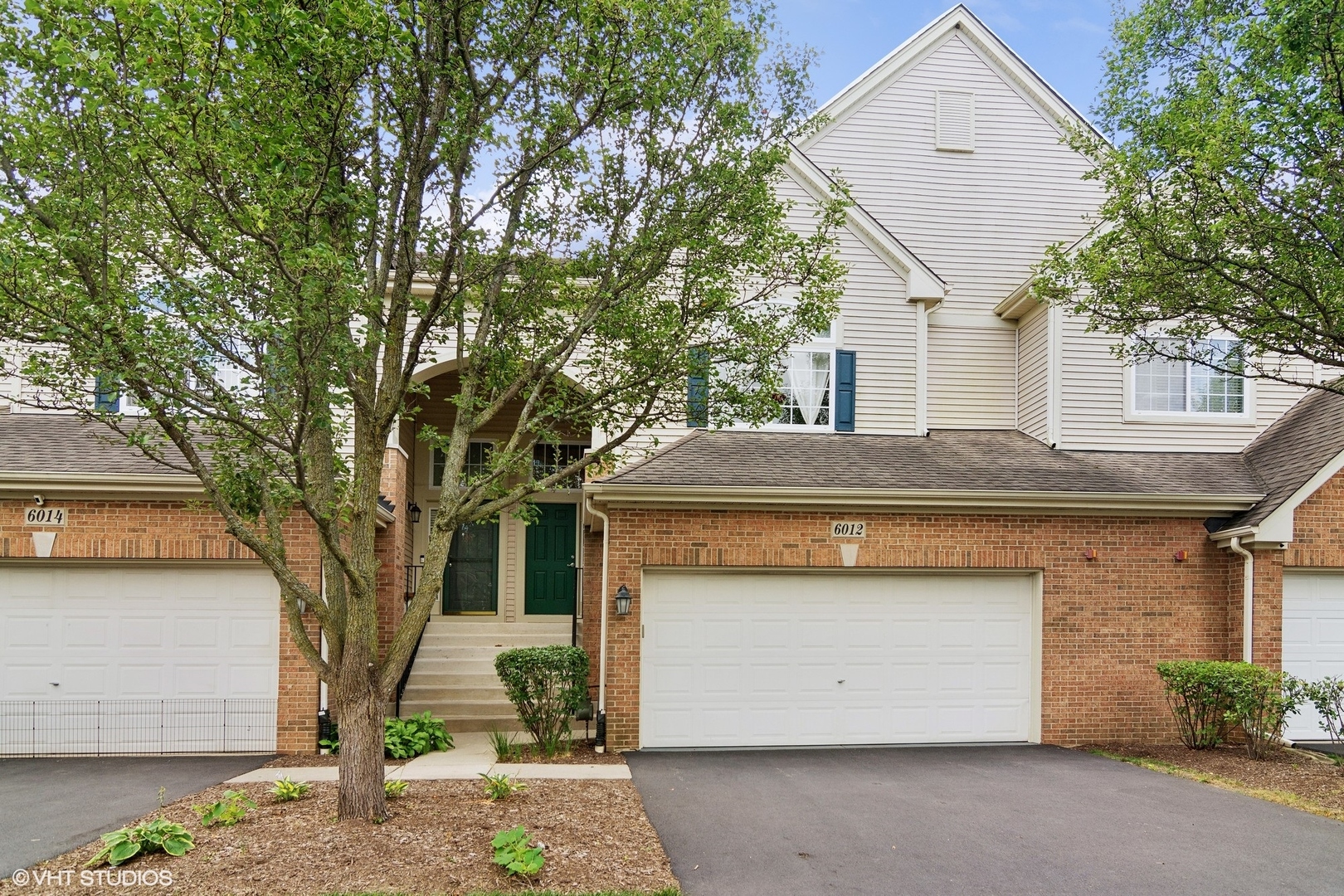 a front view of a house with a garage