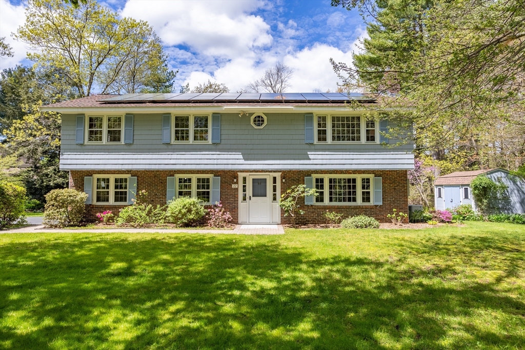 a front view of house with yard and green space