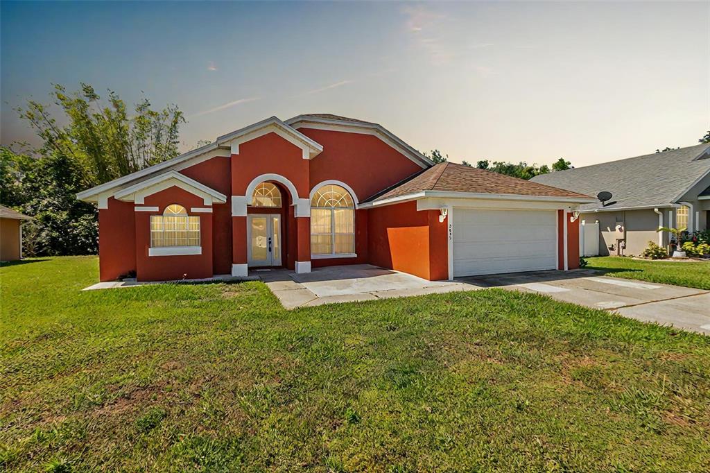 a front view of a house with a yard and garage