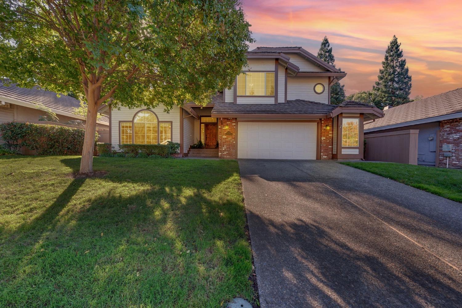 a front view of a house with a yard and garage