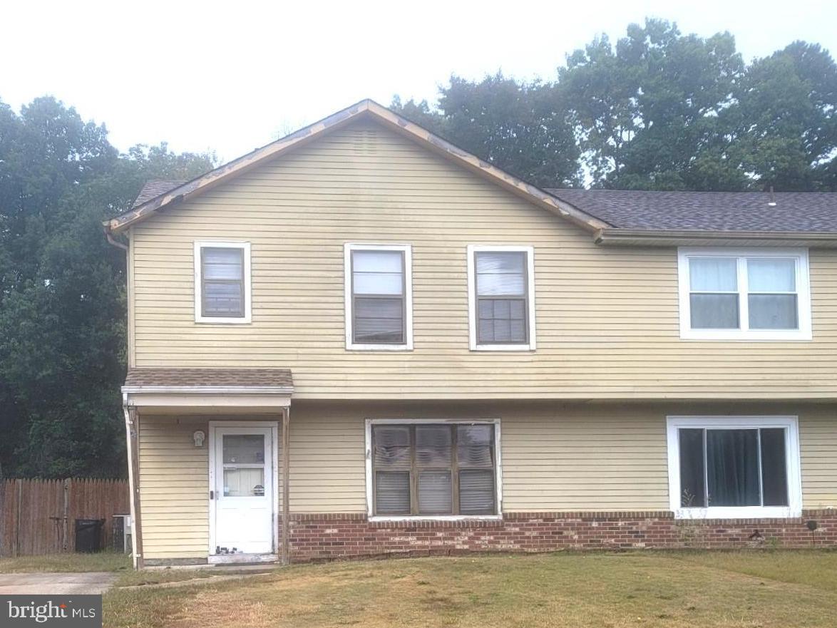 a front view of a house with large windows