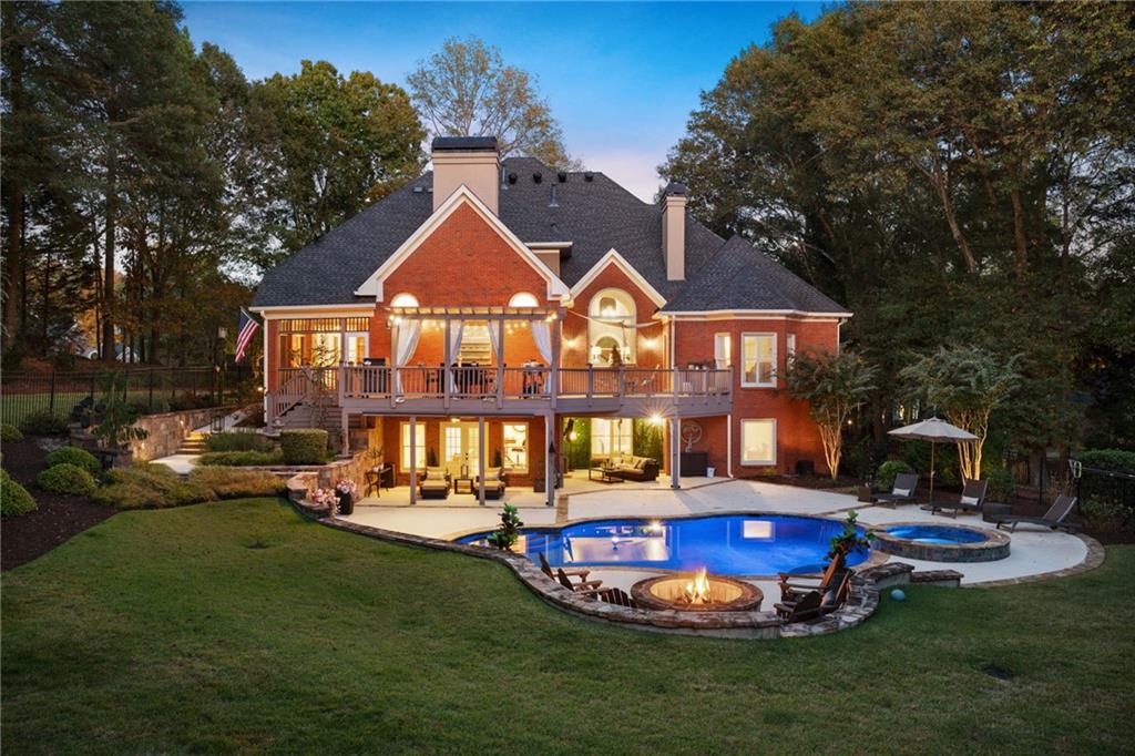 a swimming pool with outdoor seating and yard