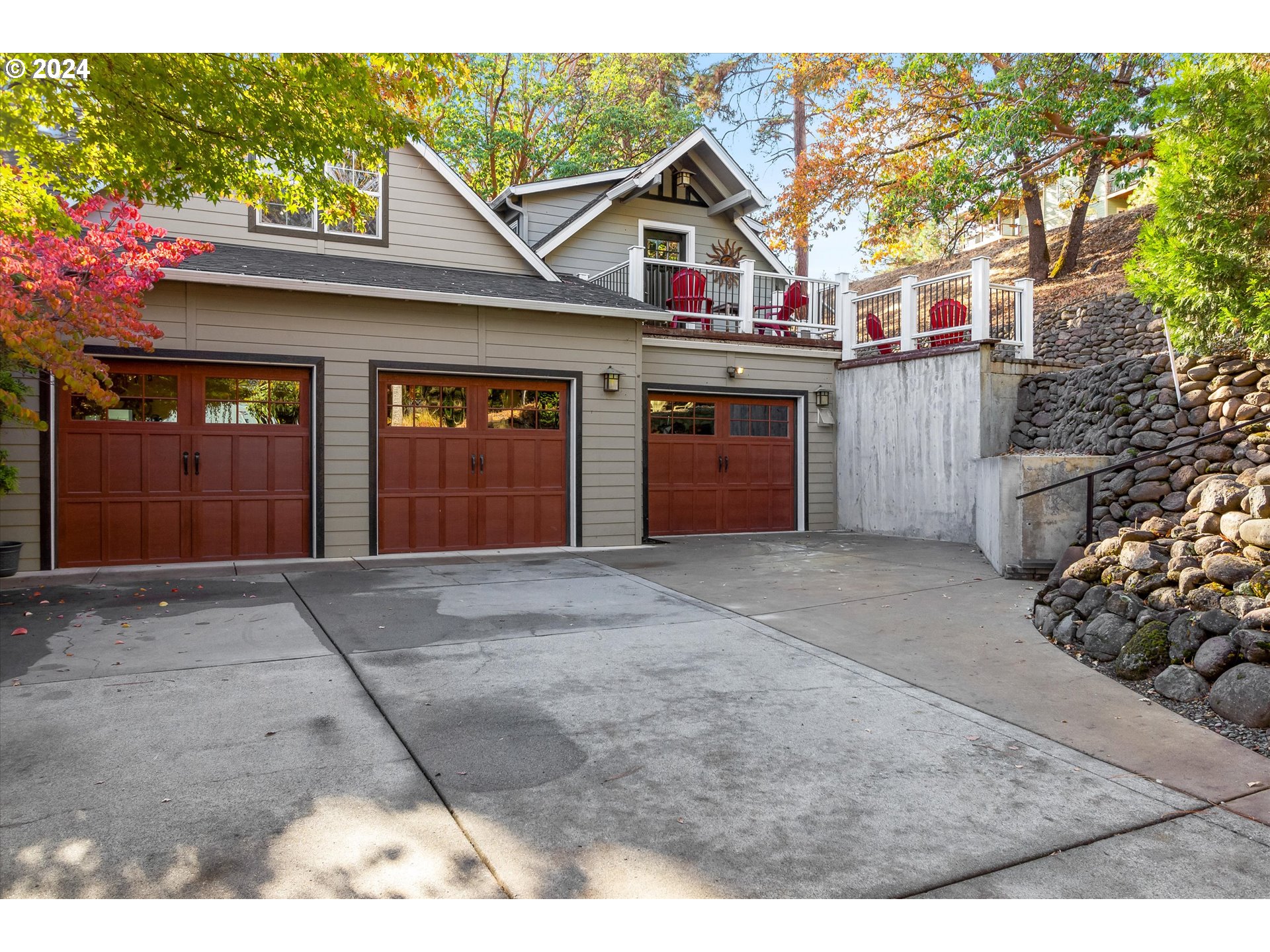 a view of a house with a garage and sitting area