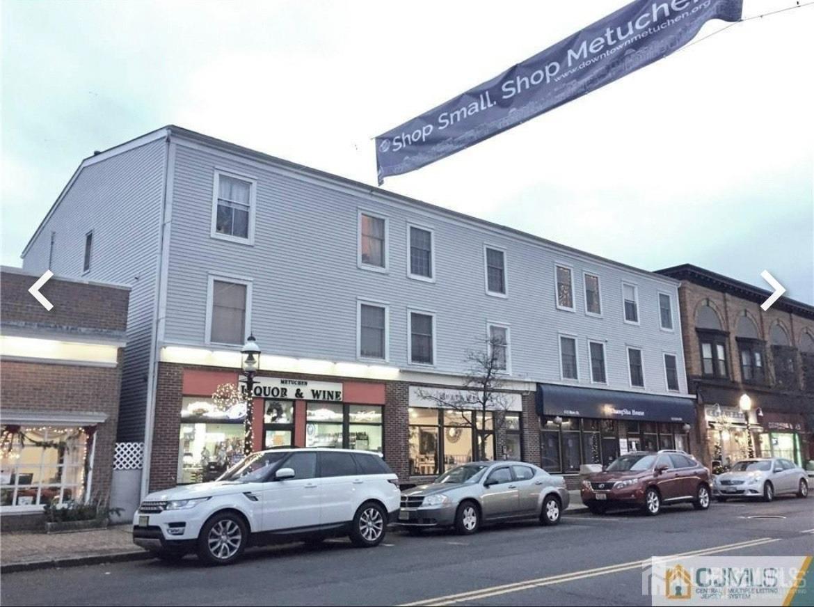 a view of a cars park in front of a building