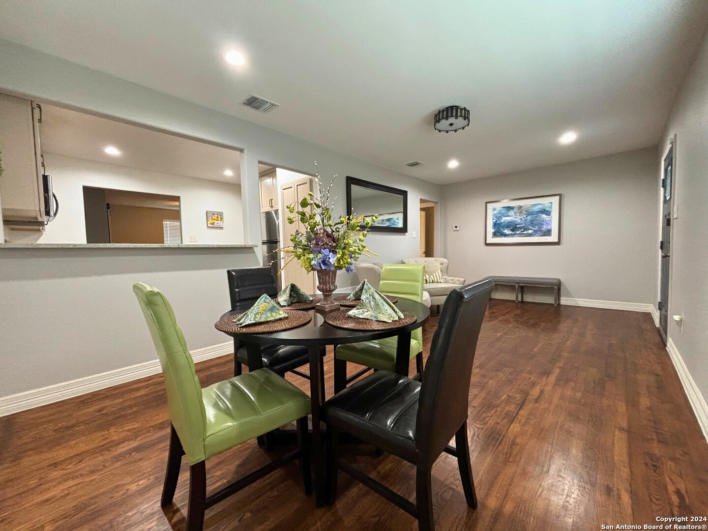 a view of a dining room with furniture and wooden floor