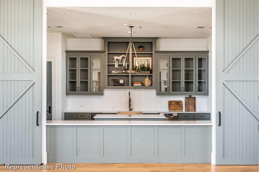 a kitchen with stainless steel appliances granite countertop a sink and cabinets