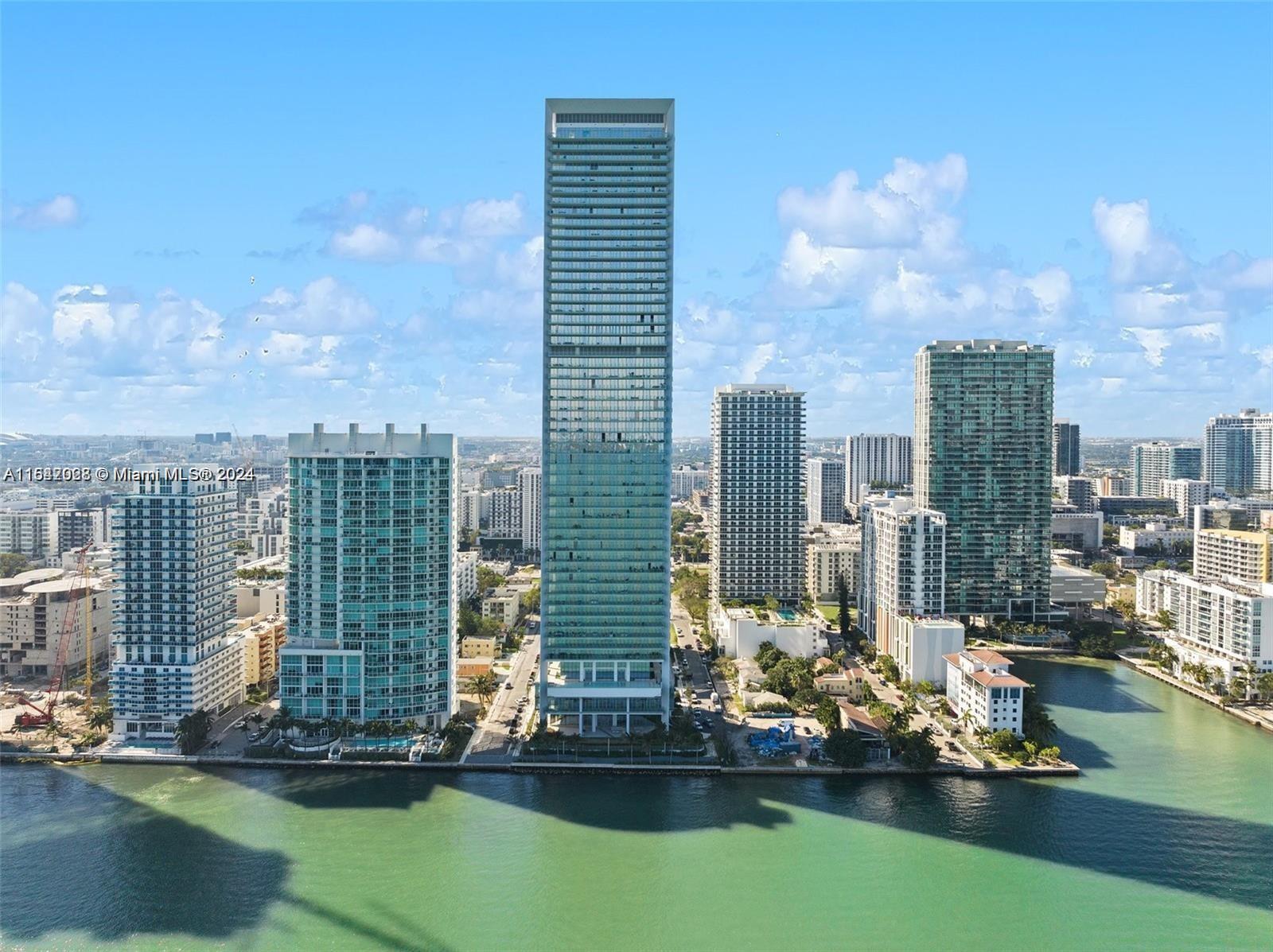 a view of a lake with tall buildings