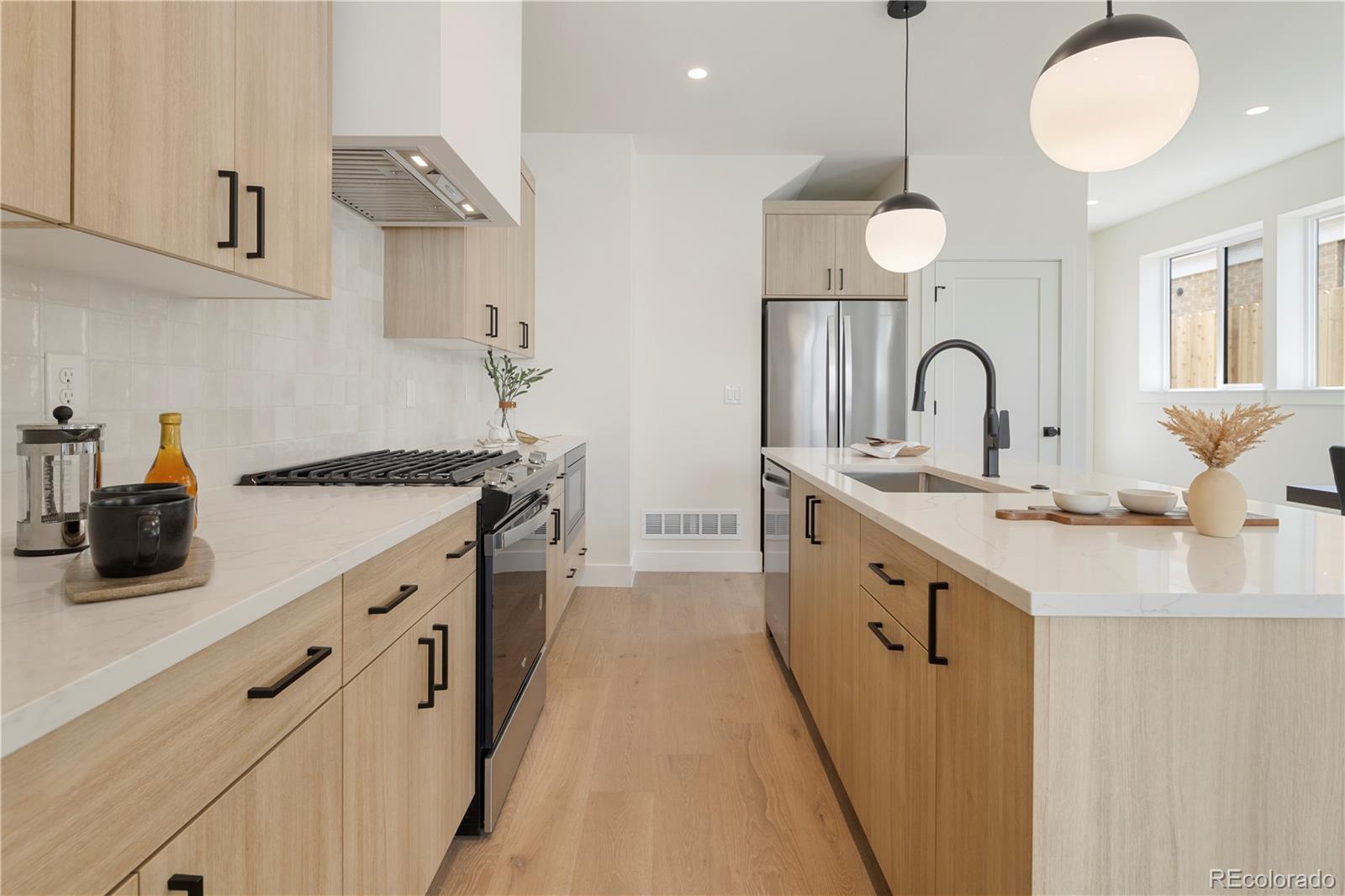 a kitchen with cabinets a sink and appliances