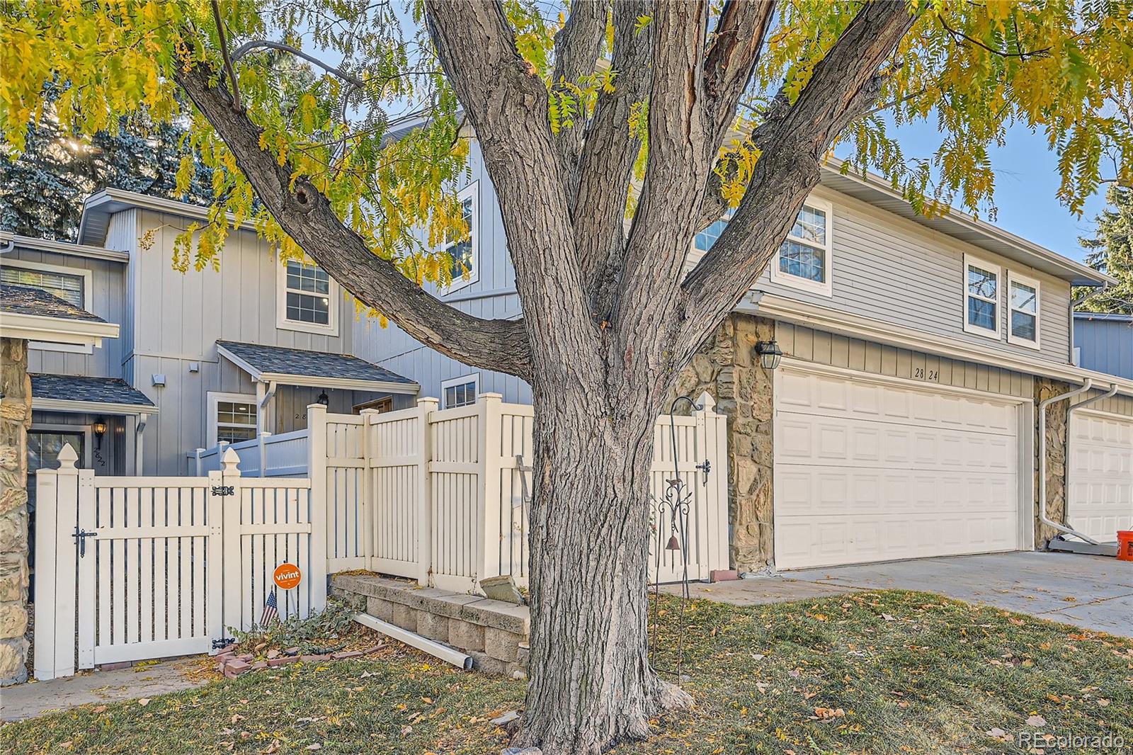 a front view of a house with a tree