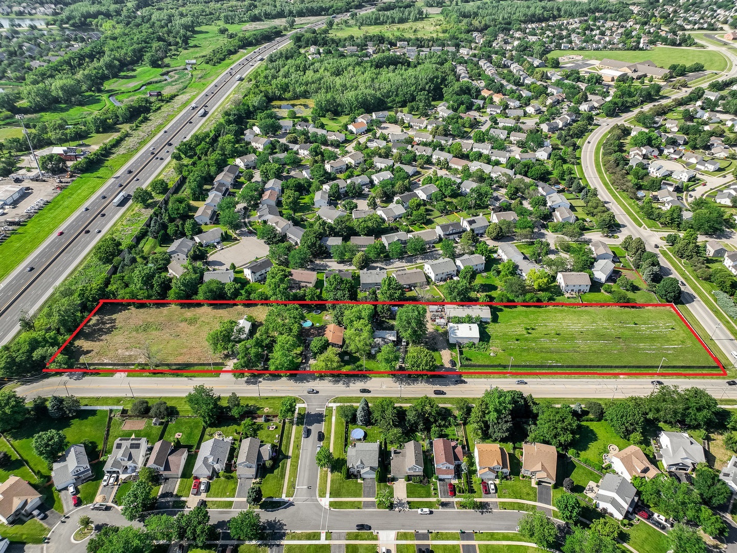 an aerial view of residential houses with outdoor space and street view