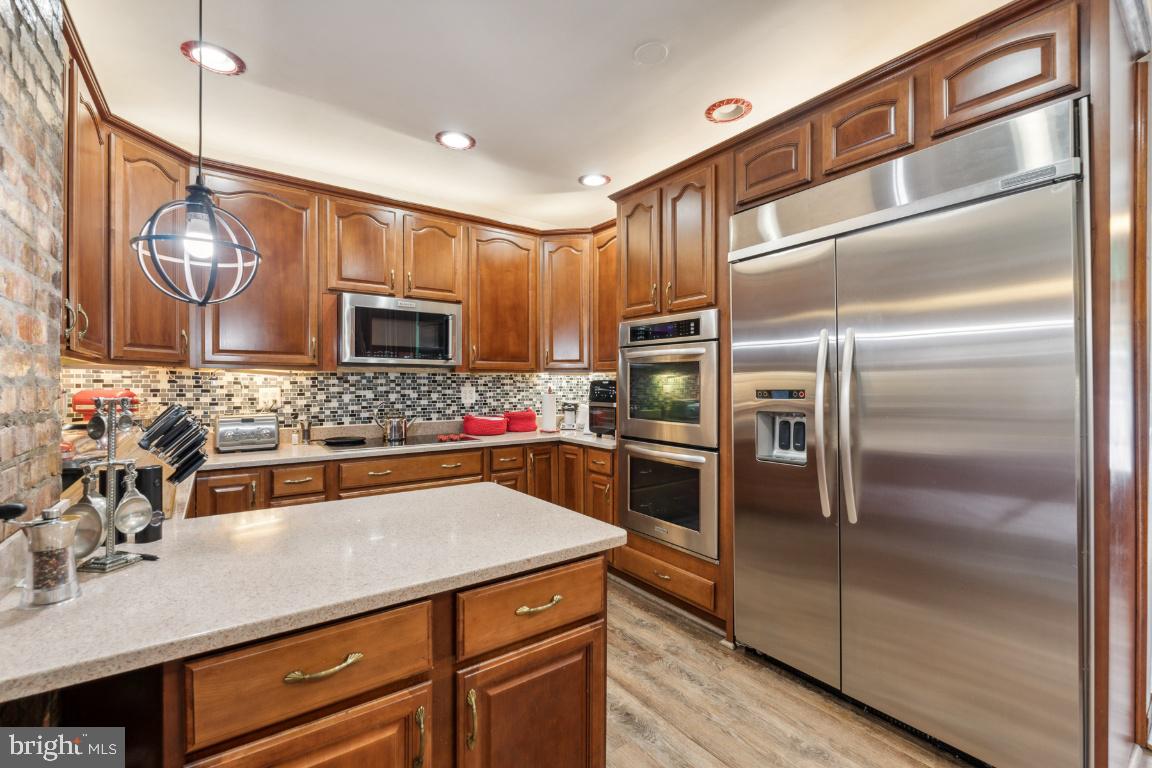 a kitchen with a refrigerator and a sink